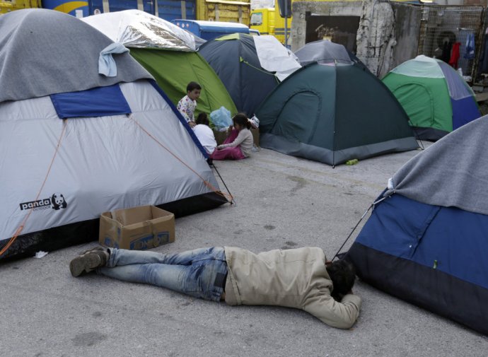 Tábor pre migrantov v Aténach je preplenený. Ľudia celý deň čakajú na rozhodnutie úradov. Foto – TASR/AP