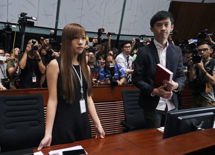 Yau Wai-ching a Sixtus Leung obklopení novinármi. Foto – AP