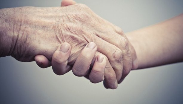 Elderly hand and caregiver