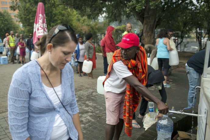 Obyvatelia Kapského mesta si plnia fľaše pitnou vodou. Foto - TASR/AP