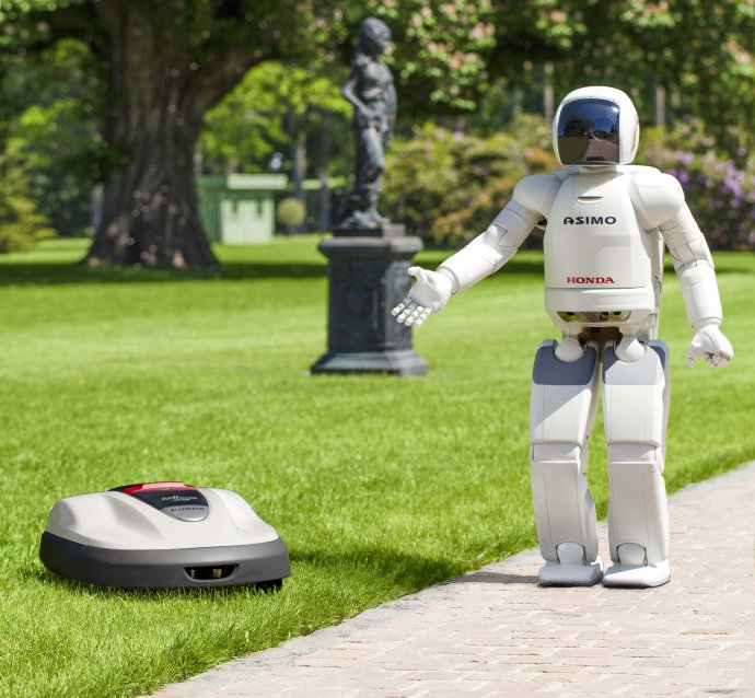 Robot Asimo s robotickou kosačkou na trávu. Foto - TASR/AP