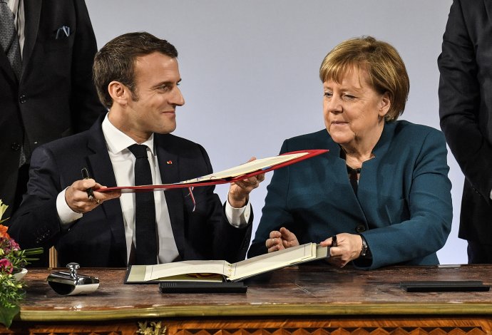 Emmanuel Macron a Angela Merkelová podpisujú dohodu. Foto - TASR/AP