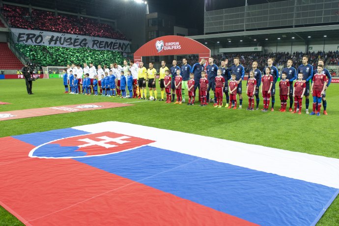 Reprezentačné družstvá Maďarska (biele dresy) a Slovenska počas hymny pred úvodným stretnutím prvého kola E-skupiny kvalifikácie EURO 2020. Foto – TASR