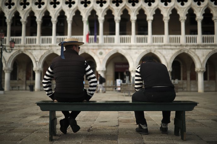 Gondolieri počas čakania na zákazníkov pri Námestí sv. Marka v talianskych Benátkach. Foto – TASR/AP