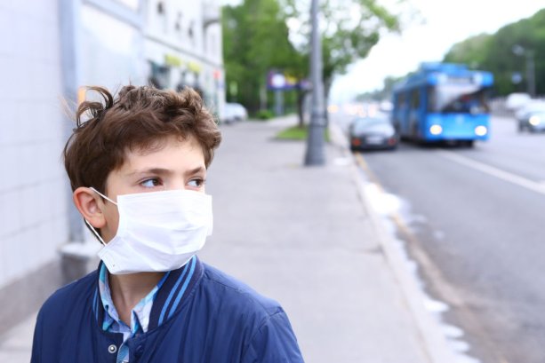 preteen handsome boy in protective mask on the urban background; Shutterstock ID 427982332