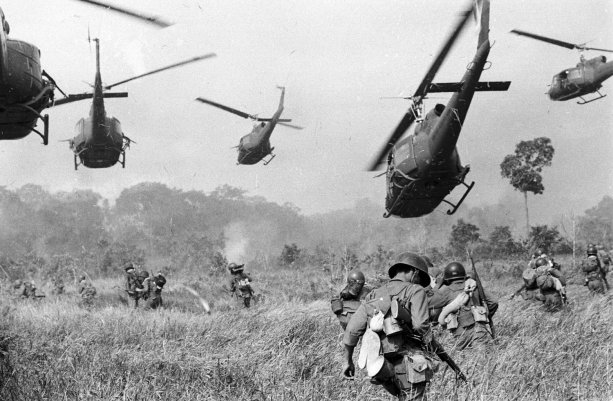Hovering U.S. Army helicopters pour machine gun fire into a tree line to cover the advance of South Vietnamese ground troops in an attack on a Viet-Cong camp 18 miles north of Tay Ninh, near the Cambodian border, March 1965. (AP Photo/Horst Faas)