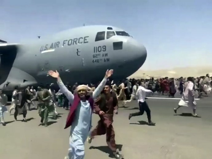 Odletovú dráhu na kábulskom letisku zaplnili stovky ľudí, ktorí sa chcú dostať z krajiny. Foto – TASR/AP