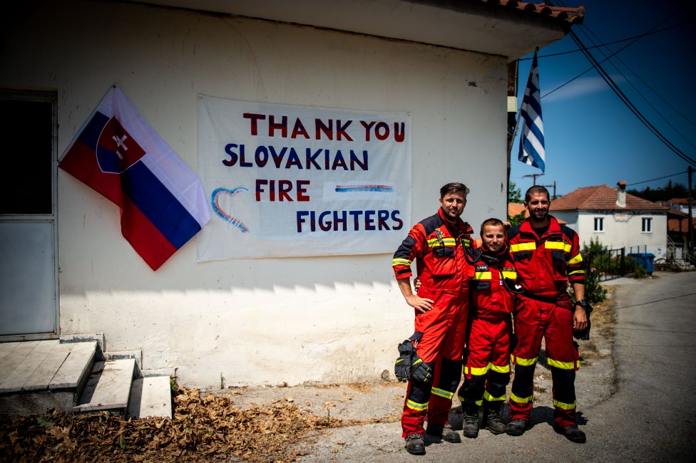 Hasiči Kamil, Otto a Jozef. V gréckej dedine je vyvesené poďakovanie slovenským hasičom. Foto N - Vladimír Šimíček