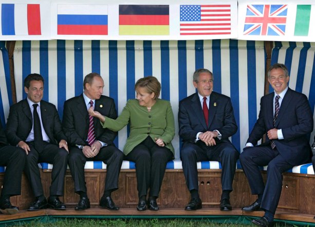 French President Nicolas Sarkozy, Russian President Vladimir Putin, German Chancellor Angela Merkel, U.S. President George W. Bush and British Prime Minister Tony Blair sit underneath their respective national flags in a beach chair during the G8 Summit in Heiligendamm, Germany, 07 June 2007
