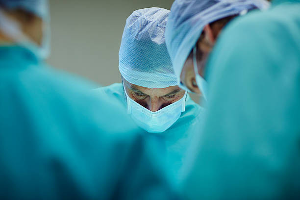 Male surgeons working in operating room at hospital