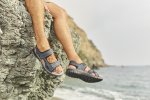 Pánske nohy v sandáloch Rieker pri mori